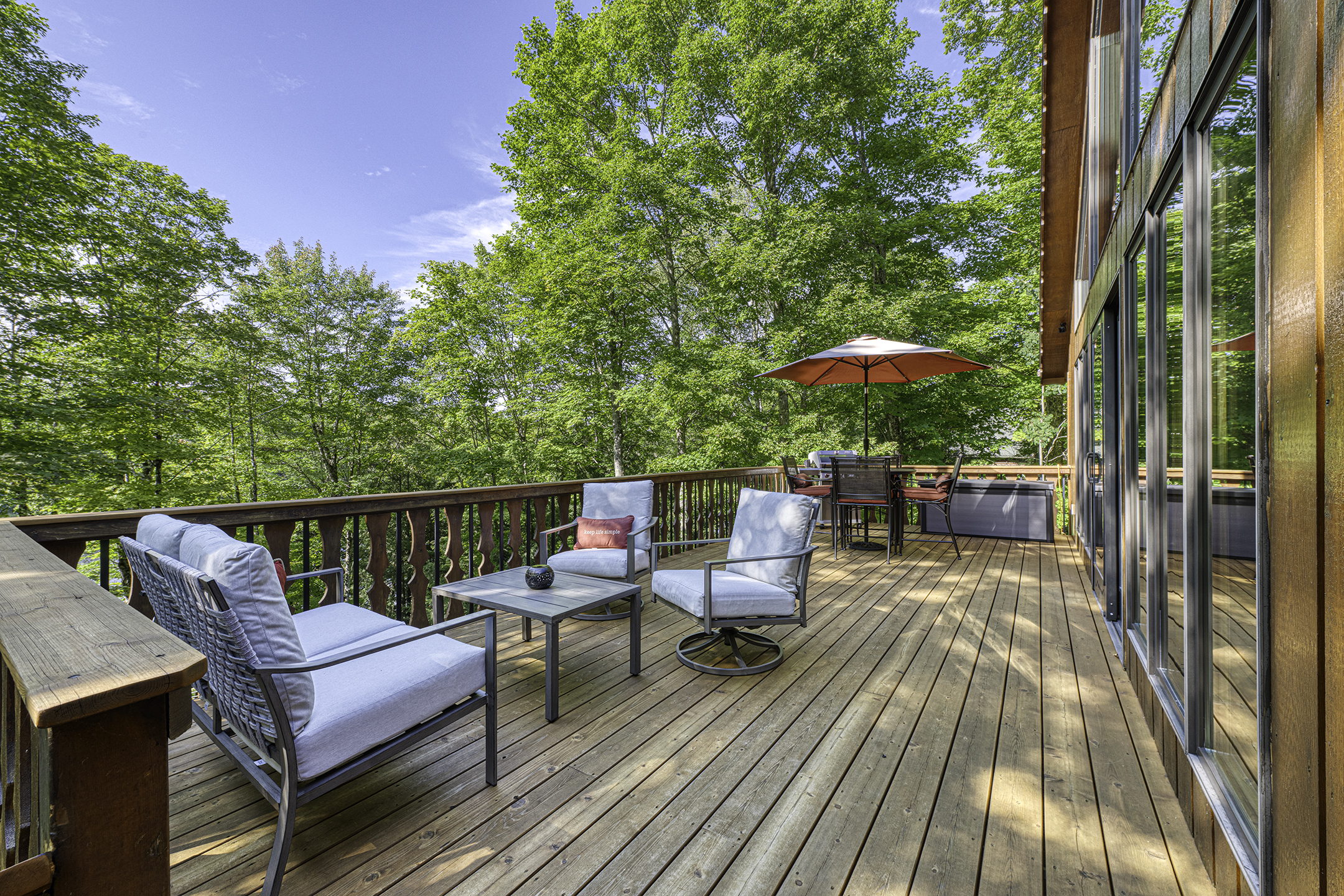 Elevated lakeside deck with outdoor seating.