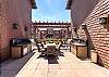 Community patio with fire pit, two gas grills, and outdoor dining table