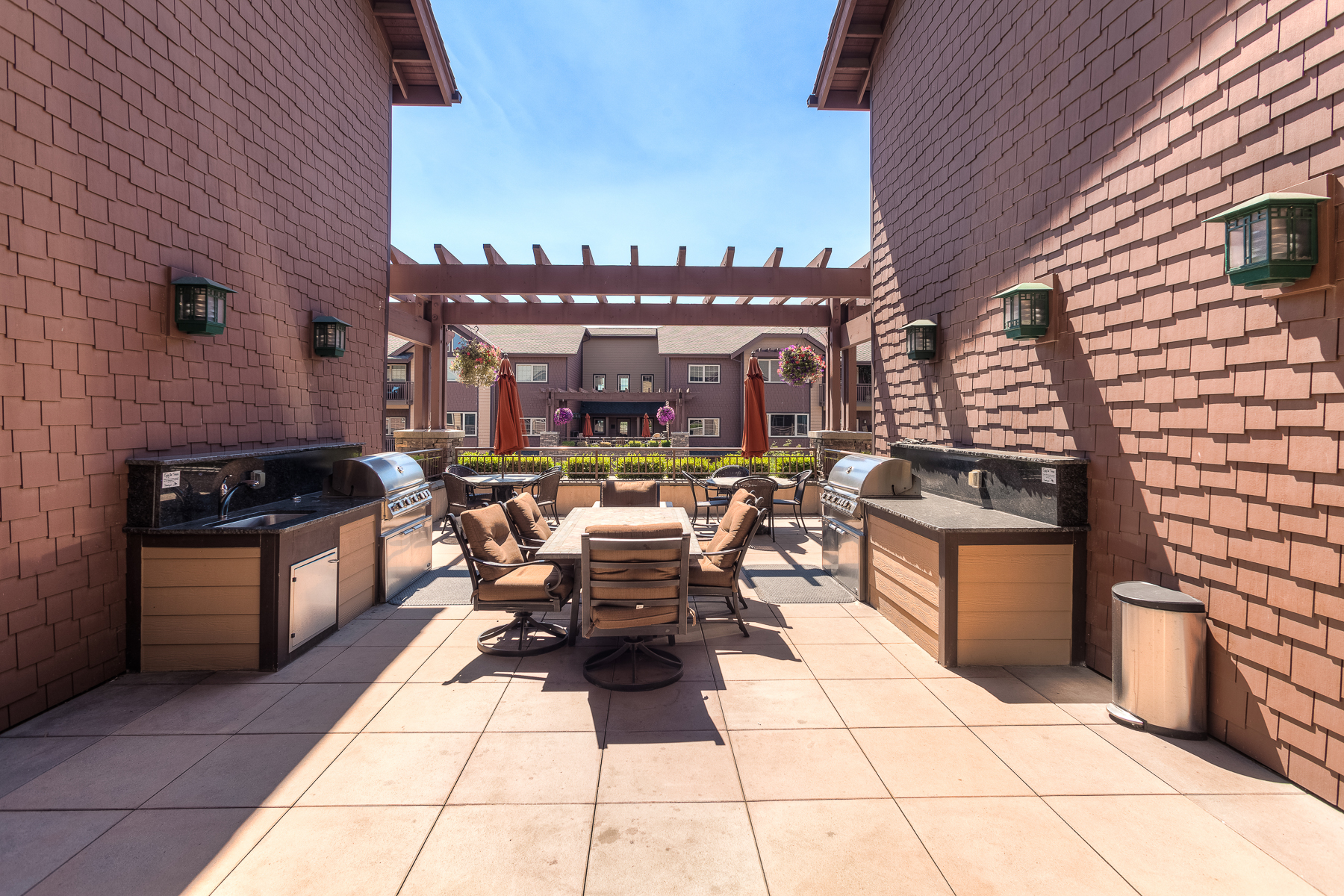 Community patio with fire pit, two gas grills, and outdoor dining table