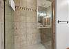 En suite bathroom with tiled walk-in shower.