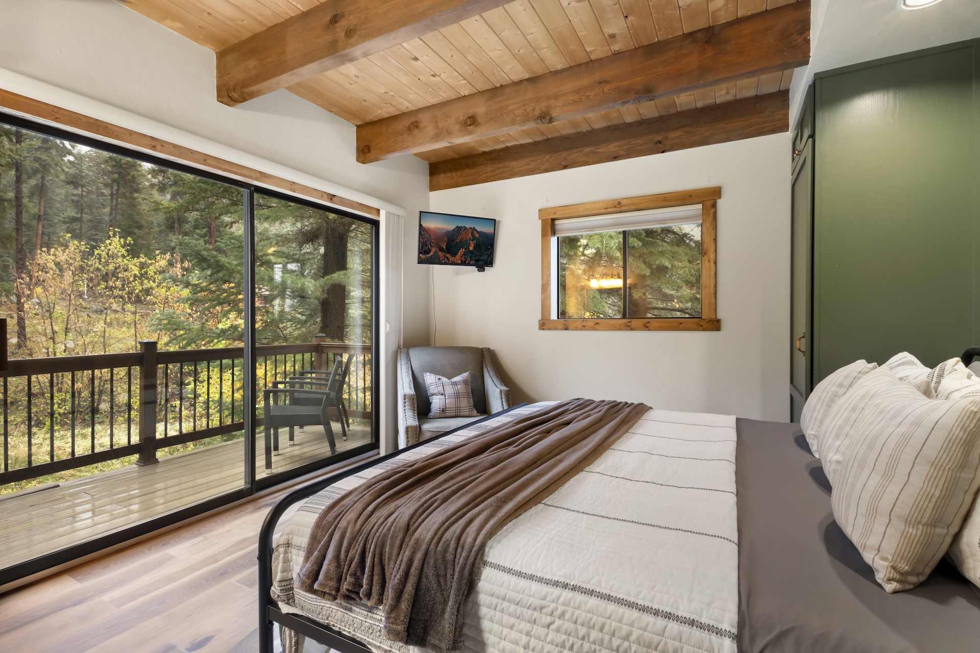 Primary Bedroom: King Bed, private vanity, TV, and sliding glass doors to a private deck (3rd Floor)