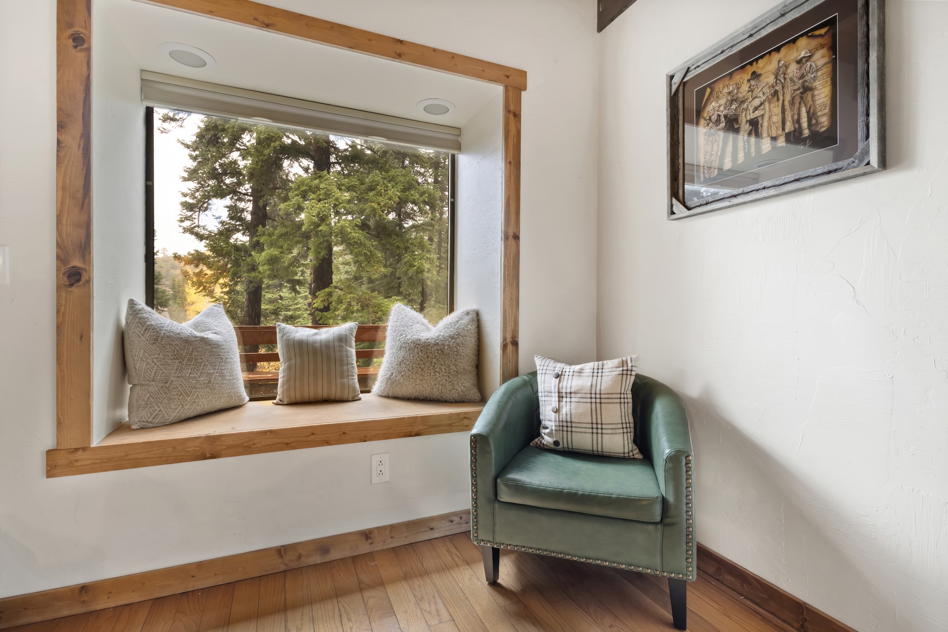 Expansive living room with plenty of seating, bay windows, traditional rock hearth, electric stove and smart TV.