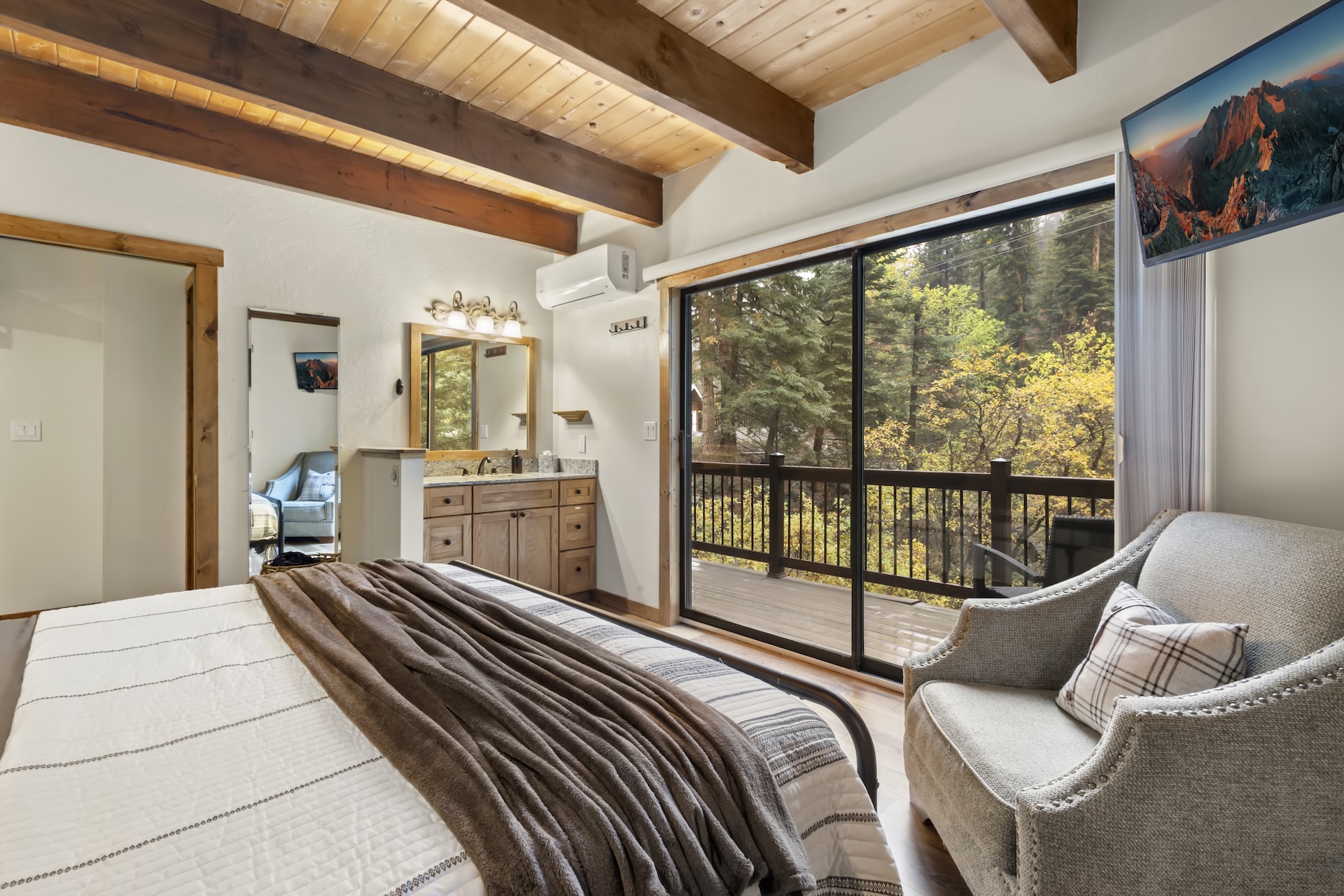 Primary Bedroom: King Bed, private vanity, TV, and sliding glass doors to a private deck (3rd Floor)