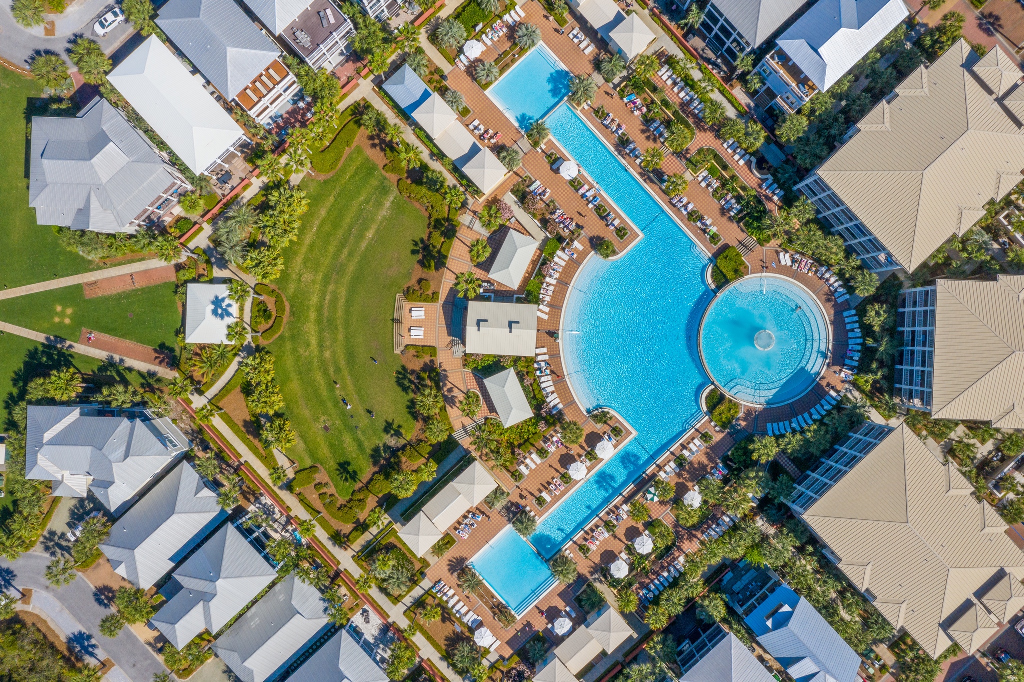 Aerial view of the resort pool and coastal neighborhood near Beauty and the Beach and Scenic Highway 30A