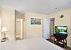A second view of the king bedroom, showing the private ensuite entrance and TV setup. It’s light-filled, easy to navigate, and designed for slow mornings and quiet nights.

