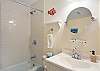 Located off the hallway, this shared bath features a tub/shower combo, cheerful fish décor, and plenty of counter space. It’s convenient to both guest bedrooms and ideal for families with kids.


