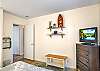 A second look at the full bedroom reveals charming coastal decor, a smart TV, and easy hallway access. It’s a calm, clean space with just enough personality to feel like vacation.


