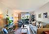 The heart of this St. Simons vacation rental, this spacious living room opens to the private patio and blends comfort with casual island style. Includes streaming TV, ample seating, and natural light that stretches all the way to the kitchen.

