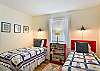 Classic twin beds, cheerful lighting, and a window that lets in the Georgia sun. Whether it’s the kids or just two friends splitting the room, this bedroom is bright, functional, and ready to recharge.


