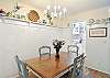 Tucked between the kitchen and living area, this dining room features built-in shelving, beachy accents, and seating for six. A perfect spot for seafood feasts, board game battles, or that first cup of coffee.

