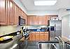 Another view of the kitchen shows off prep space, modern appliances, and thoughtful flow. Everything you need for big breakfasts or quick beach-day fuel-ups.