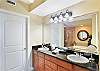 Spacious dual-sink vanity with granite countertops and plenty of lighting—ideal for getting ready without bumping elbows. Full view into the soaking tub and walk-in shower completes the suite.