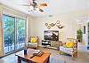 Catch filtered sunlight through the balcony doors and a clear view toward the bedroom hallway. It’s a well-laid-out space that flows easily from living to sleeping to outdoors.
