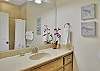 The guest bedroom has its own en-suite bath with a spacious vanity and combination tub/shower—ideal for kids, friends, or anyone who wants a little extra privacy.

