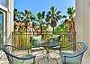 Private balcony with palm tree views at Sea Point Lodge 208 in St. Simons Island. This cozy outdoor space is perfect for coffee, cocktails, or soaking up the coastal breeze.


