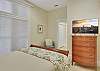 A second angle on the guest bedroom, with natural light, a smart TV, and en-suite bath access just around the corner. Comfortable, private, and ideal for traveling companions.

