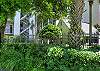 Lush landscaping surrounds the rear stairwell entrance to Sea Point Lodge. The gated complex offers both stair and elevator access to every unit.

