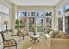 Wall-to-wall windows bring the palms indoors in this bright sitting room off the main living area. It's the perfect place to read, sip coffee, or just enjoy the view from the cool of the indoors.

