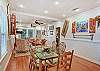 Open-concept living and dining areas make it easy to gather, share meals, and relax—all under the warm glow of The Stumble Home’s island-inspired decor.