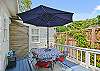Just steps from the outdoor shower, this deck setup offers shaded seating and easy access for post-beach cooldowns or casual hangouts.