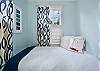 First of two twin beds in the sleeping nook—bright, cozy, and tucked beside a sunny window just off the living room.
