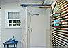 Rinse off after a sandy adventure—private outdoor shower tucked just off the deck.