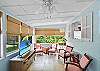 Seagull Cottage’s bright and airy sunroom offers garden views, natural light, and peaceful charm—perfect for morning coffee, board games, or quiet reading time during your St. Simons Island stay.
