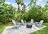 Relax under the palms in Seagull Cottage’s private, fenced backyard—complete with firepit, Adirondack chairs, and tropical landscaping. Perfect for winding down after a day in Pier Village.
