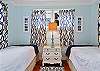 Compact sleeping nook with two twin beds—ideal for kids or friends. Space is small and cozy, tucked just off the living room with folding privacy doors.

