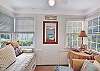 The sunny front room at 204 Ashantilly Avenue features a daybed and space to stretch out, sip coffee, or sneak in a midday nap on St. Simons Island.