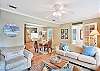 The main living space at 204 Ashantilly Avenue is light-filled and inviting, with a peek into the dining area for easy-flow vacation living.

