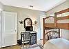 This sunny bunk bedroom at 204 Ashantilly Avenue features two twin beds and a full-size desk—great for kids, cousins, or a little remote work after the beach.

