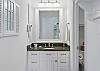 The primary suite’s ensuite opens with a granite-topped vanity and great lighting, leading to a walk-in shower tucked just behind the door. It’s clean, bright, and set up for real-life mornings.