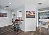 Start your day with coffee at the breakfast bar, or sip something stronger while debating the artistic merit of mermaid wall art. Built-in bookshelves hold shells, books, and a little island personality.