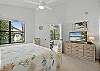 The master bedroom includes a queen bed, smart TV, and private attached bath. Windows on two sides keep things airy, while the ensuite makes it feel just a little more grown-up than the rest of the group.