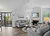 From the fireplace to the screened porch, this second look at the living room shows off how light moves through the space. Comfortable seating, clean lines, and a peek outside to remind you you're on island time.