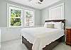 This queen bedroom faces the front of the house and gets incredible natural light through oversized windows. It shares easy access to the hallway bath and works just as well for couples as it does for solo guests who like to spread out. Clean, calm, and a welcome place to land.