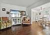 This angle shows the home’s easygoing layout—natural flow from the living room to the dining area, with bright windows on both sides. It’s the kind of space where the morning starts slow and the day ends with takeout from Porch or pizza at Mellow Mushroom.