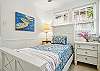 This twin bedroom is small but mighty—just the right size for younger guests, solo sleepers, or anyone who needs their own space. The coastal art, crisp linens, and bright windows make it feel both personal and part of the whole home’s cheerful rhythm.