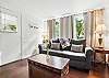 This second view of the living room highlights the soft morning light and a comfy setup for sipping coffee, streaming shows, or planning your next move. Behind that door? Frosty’s and the Village are waiting—about 30 steps away.
