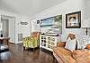 The living room at this St. Simons vacation rental brings the vibe. Natural light, a smart TV with streaming, and just the right mix of color and comfort make this your home base between beach walks and Village nights. The layout flows easily into the dining area and kitchen, perfect for lazy mornings or end-of-day recharging.

