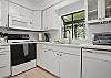 The kitchen at 412 Magnolia Avenue keeps it classic. Bright white cabinetry, a full-size fridge, and a regular drip coffee maker mean everything you need is within reach—without trying too hard. Cook, reheat, or just stock the fridge with leftovers from Iguanas, Porch, or Georgia Sea Grill (all a short walk away).