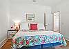 This final guest bedroom includes a queen bed, closet storage, and relaxed island style—perfect for teens, in-laws, or friends who pack light and sleep hard.