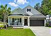  St. Simons Island beach rental with classic curb appeal, a wide driveway, and walkable access to Redfern Village.
