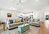 This St. Simons Island beach rental features an open-concept layout with plush seating, full kitchen, and natural light pouring in from every side.
