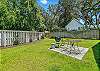 This pet-friendly St. Simons rental cottage has a fully fenced yard, charcoal grill, and patio seating—perfect for lawn games, cookouts, or four-legged zoomies.