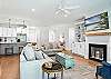 The fireplace anchors the living room with clean lines, curated art, and a layout made for unwinding after beach days or Redfern recaps.

