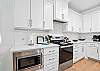 Fully equipped with microwave, toaster, oven, and generous storage—this St. Simons rental kitchen is ready for anything from cereal to shrimp scampi.