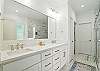 The attached primary bath features dual sinks, soft lighting, and a serene layout—just the right mix of form and function.