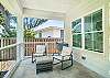 The back deck wraps around with multiple lounge zones—perfect for quiet mornings, reading in the shade, or keeping an eye on the backyard action.